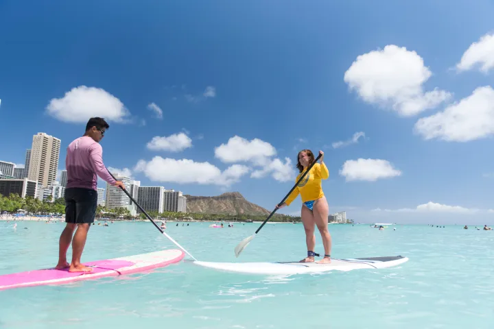 a girl riding a wave on a surfboard in the water