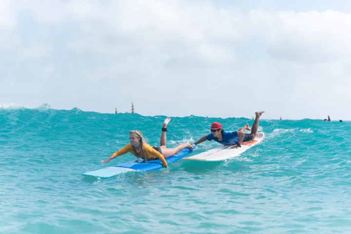 a person riding a surf board on a body of water