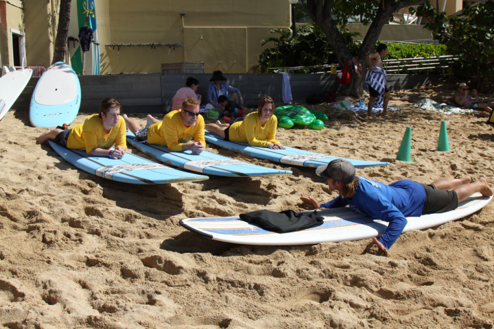 a group of people lying on a sandy beach
