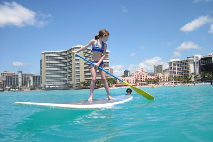 a person riding a surf board on a body of water