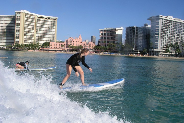 a man riding a wave on a surfboard in the water