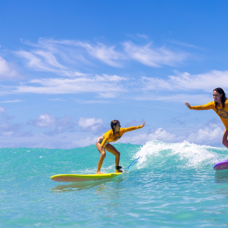 a man riding a wave on a surfboard in the water