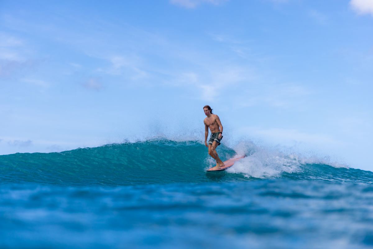 unnamed (17) a man riding a wave on a surfboard in the ocean