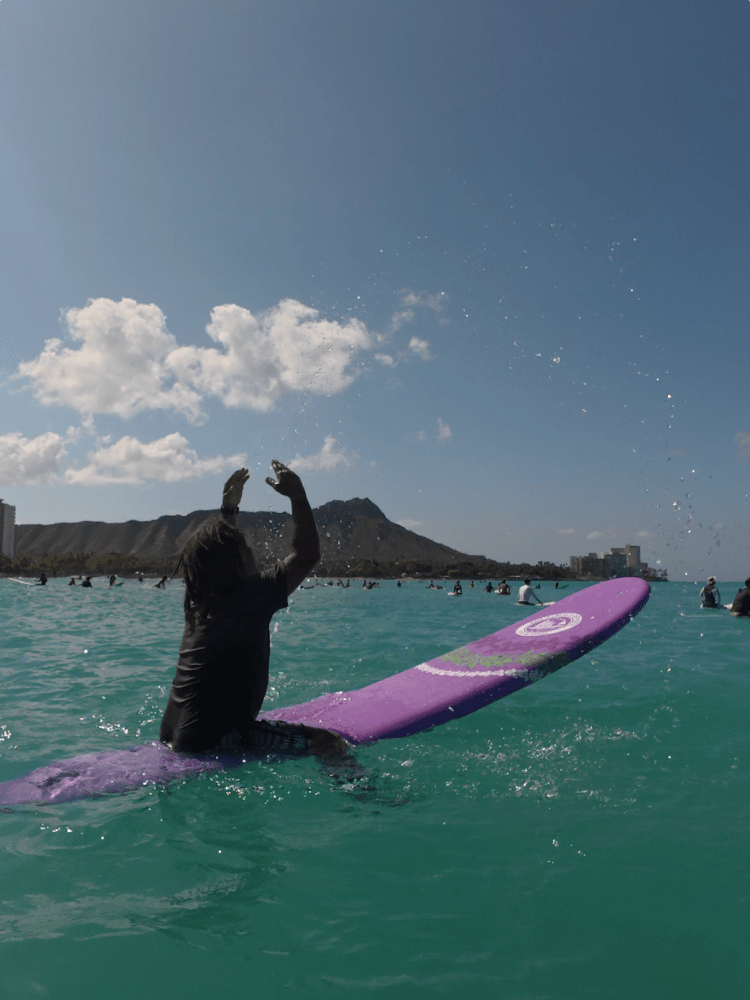 a girl riding a wave on a surfboard in the water