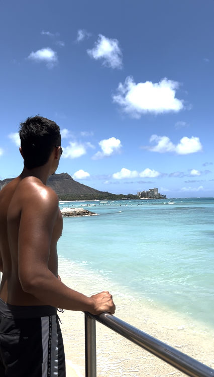 a man standing next to a body of water