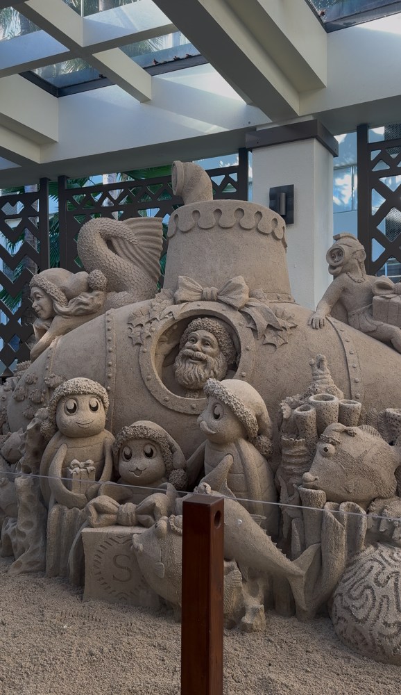 Sand sculpture of Santa underwater with sea creatures and a submarine.