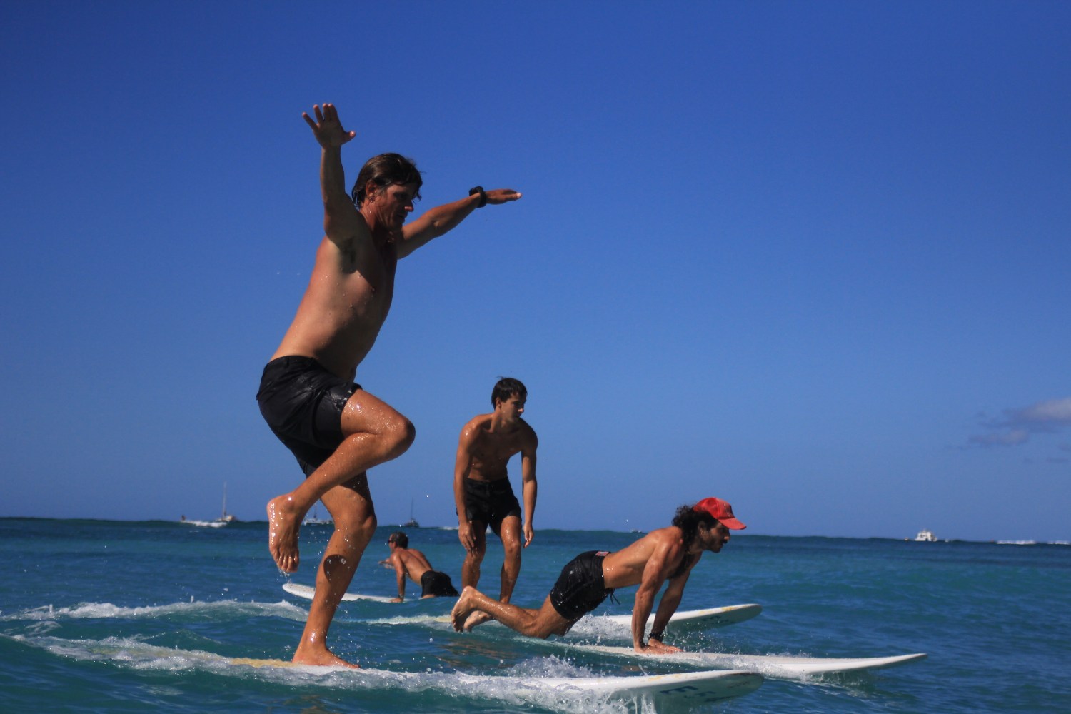 Group of people surfing on a clear day with blue skies.